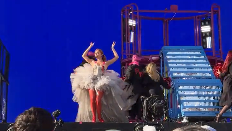 Charli screams with pure joy during the concert, capturing peak emotional intensity.
![